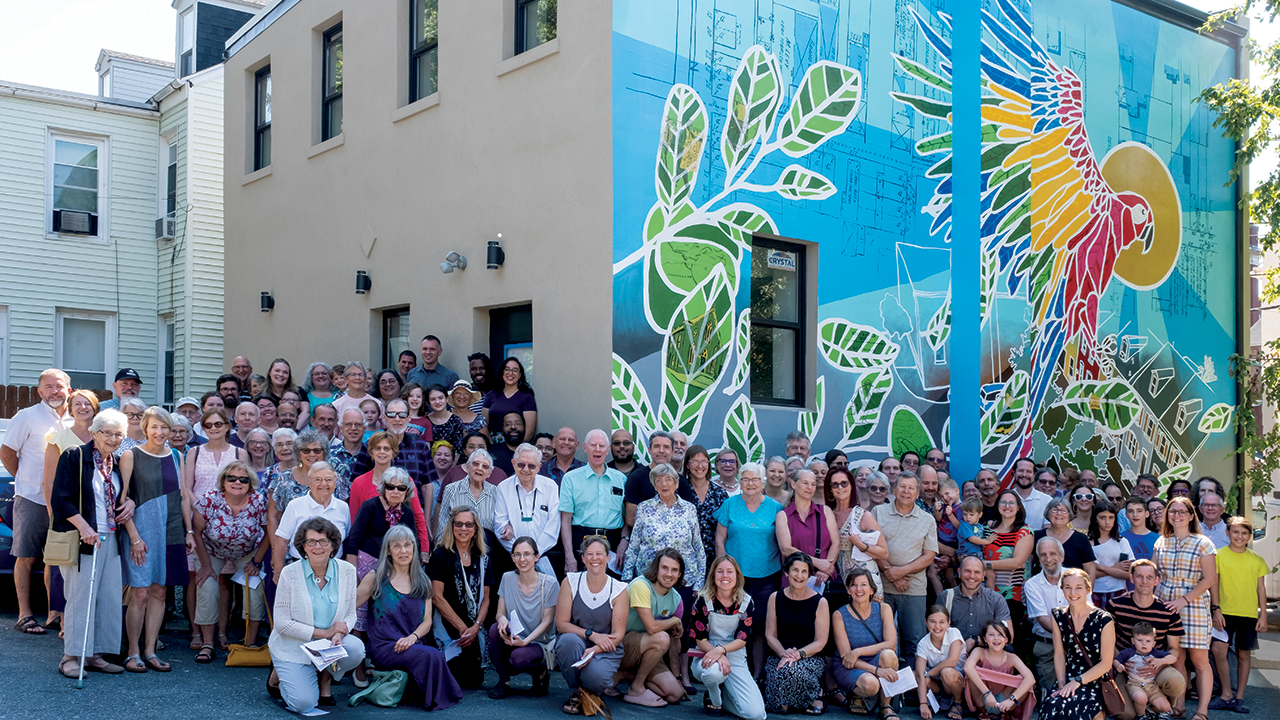 Members of Community Mennonite Church of Lancaster in Pennsylvania celebrate a blessing for the congregation’s new mural on Aug. 27. — Joseph Gascho