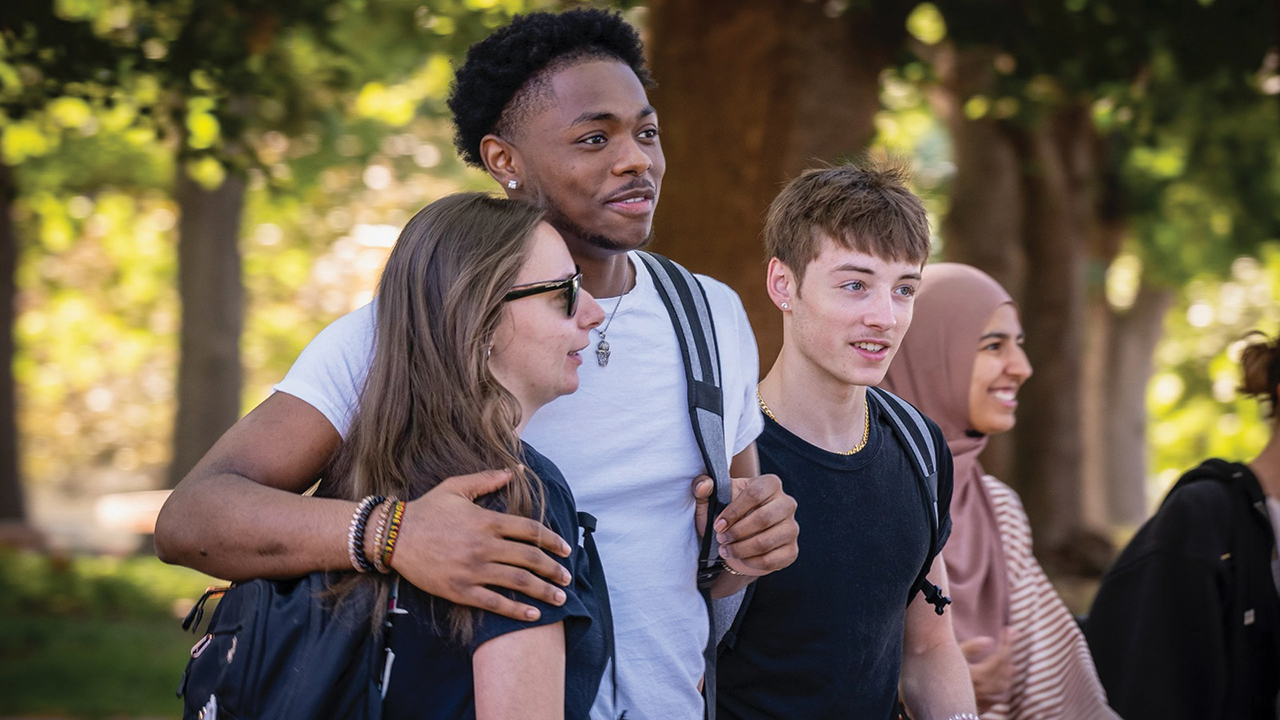Bethel College students Emily Demartino of Newton, Carmelo Yakubu of Katy, Texas, Donovan Ringenbach of Newton, and Rabia Can of Wuppertal, Germany, after the annual Walk of Welcome on the first day of fall semester classes in August. — Jim Turner/Bethel College