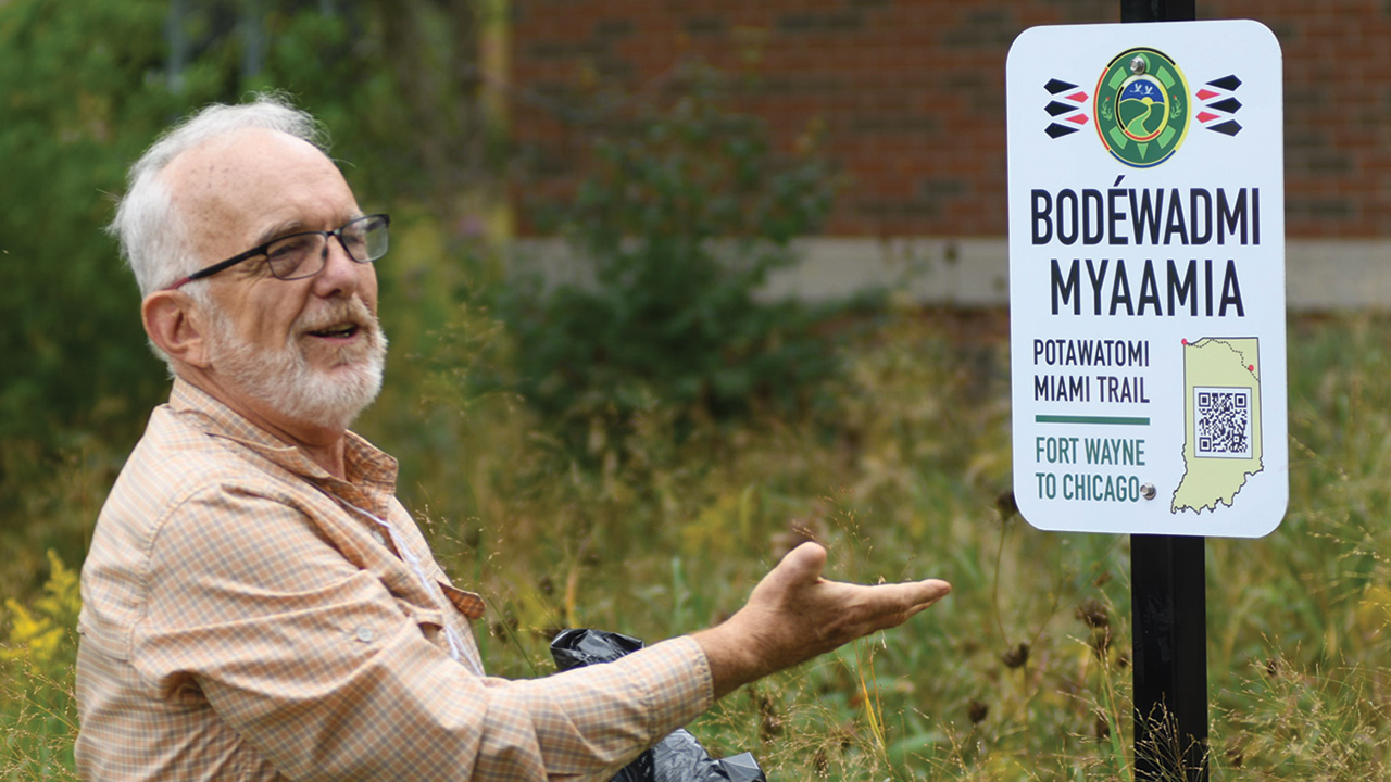 Luke Gascho, executive director emeritus of Merry Lea Environmental Learning Center, unveils a sign marking the Potawatomi-Miami Trail on Sept. 29 in Elkhart, Ind. — David Fast/MMN