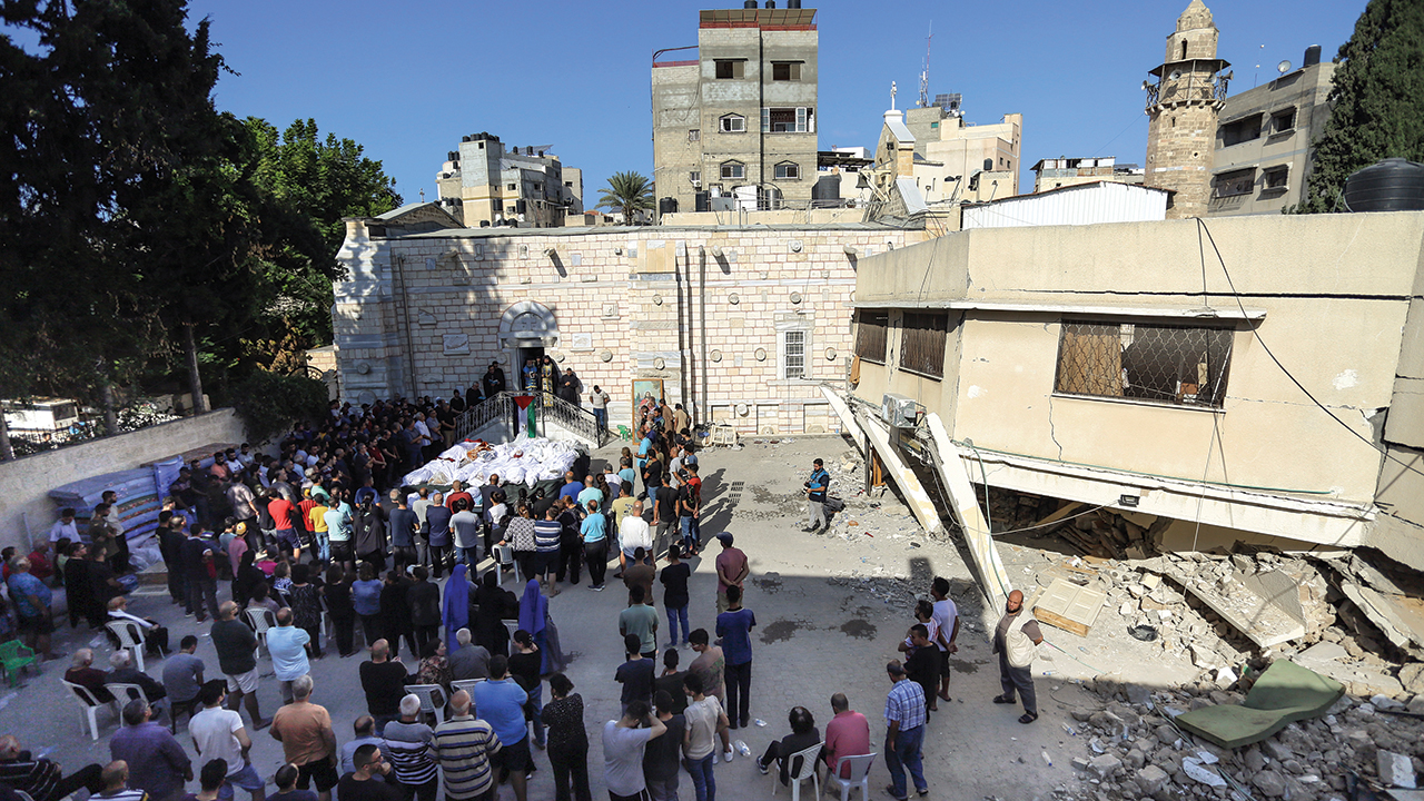 Relatives attend the funeral of Palestinians who were killed in Israeli airstrikes that hit a church Oct. 19 in Gaza City. Gaza’s Health Ministry said 16 Palestinian Christians were killed. — Abed Khaled/AP