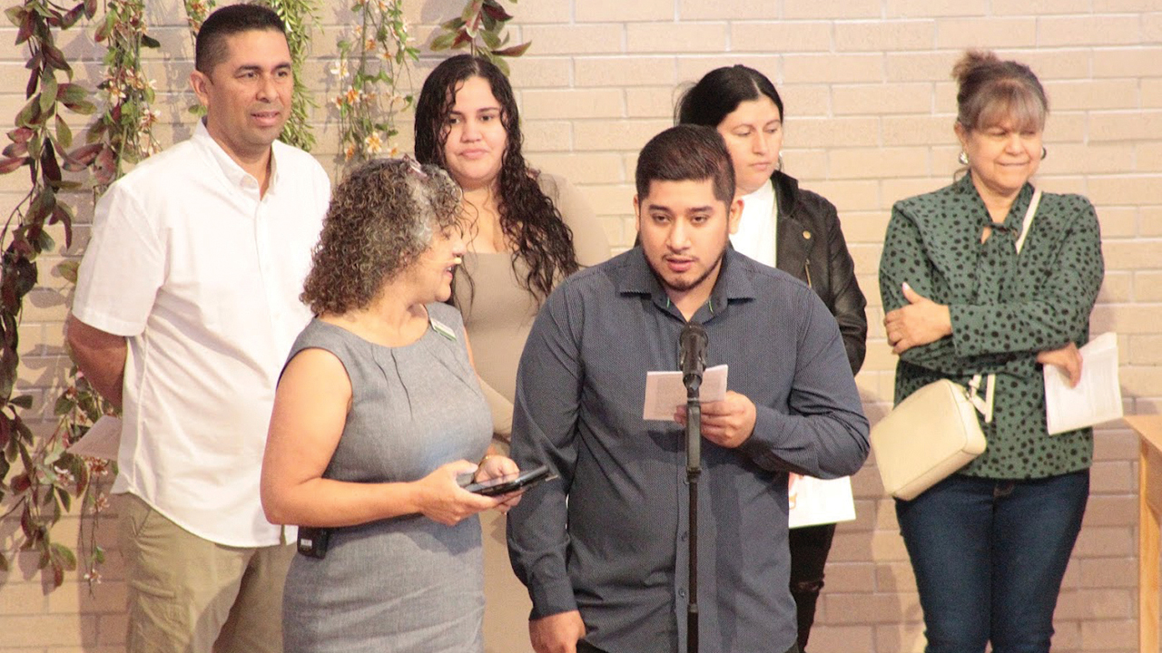 Jose “Paco” tells College Mennonite Church members about his faith during his rebaptism on Oct. 1. At left is Pastor Madeline Maldonado. — Dottie Kauffmann
