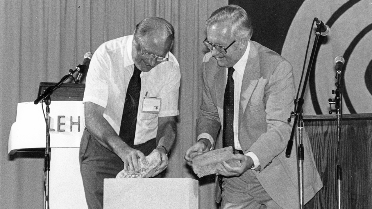At the 1983 assembly in Bethlehem, Pa., Jake Tilitzky, left, president of the General Conference Mennonite Church, and Ross Bender, moderator of the Mennonite Church, placed stones representing their denominations atop a cornerstone. — Ron Blaum for The Mennonite and Gospel Herald
