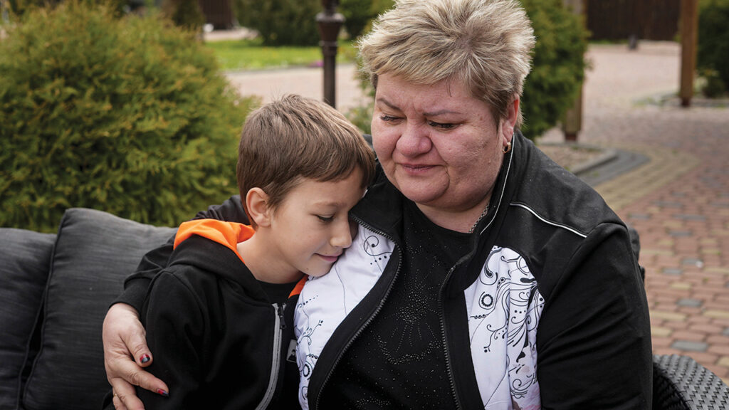 Nina Poliakova comforts her son Andrii Hinkin at a recovery camp for children and their mothers affected by the war near Lviv, Ukraine, May 3. — Vasilisa Stepanenko/AP