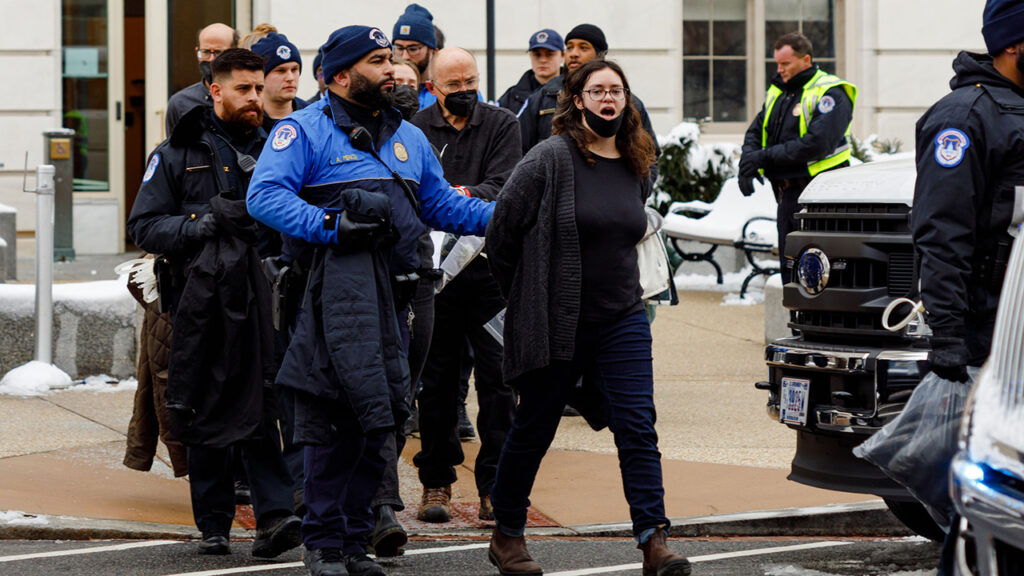 Capitol Police lead activists to vans outside the House of Representatives’ Cannon House Office Building Jan. 16 in Washington, D.C. — Rachel Schrock Photography