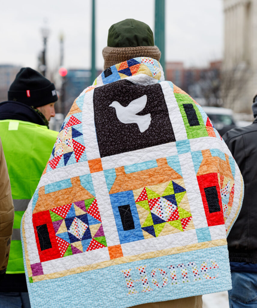 In addition to banners calling for peace in Gaza, several participants in a Mennonite Action event in Washington, D.C., carried quilts. — Rachel Schrock Photography