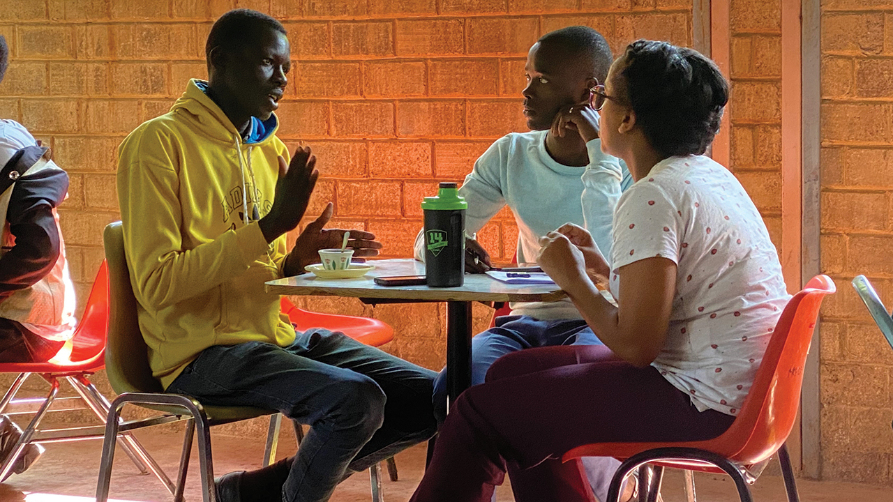 Khan “Isaac” Gatkuoth, left, speaks with Dawit Tadele and Lydia Shimelis, a married couple in Meserete Kristos Seminary’s master’s program. — Joanne De Jong/Mennonite Church Alberta