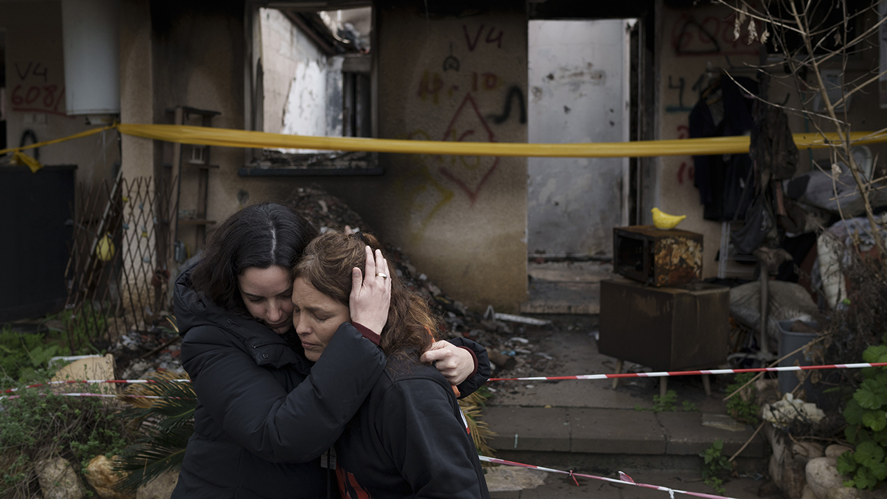 Amit Soussana, right, is embraced by a friend Jan. 29 after speaking to journalists in front of her destroyed house in the kibbutz Kfar Azza, near the Gaza Strip, Israel. Soussana was held in captivity for 55 days after be-ing kidnapped during the cross-border attack by Hamas on Oct. 7. — Leo Correa/Associated Press