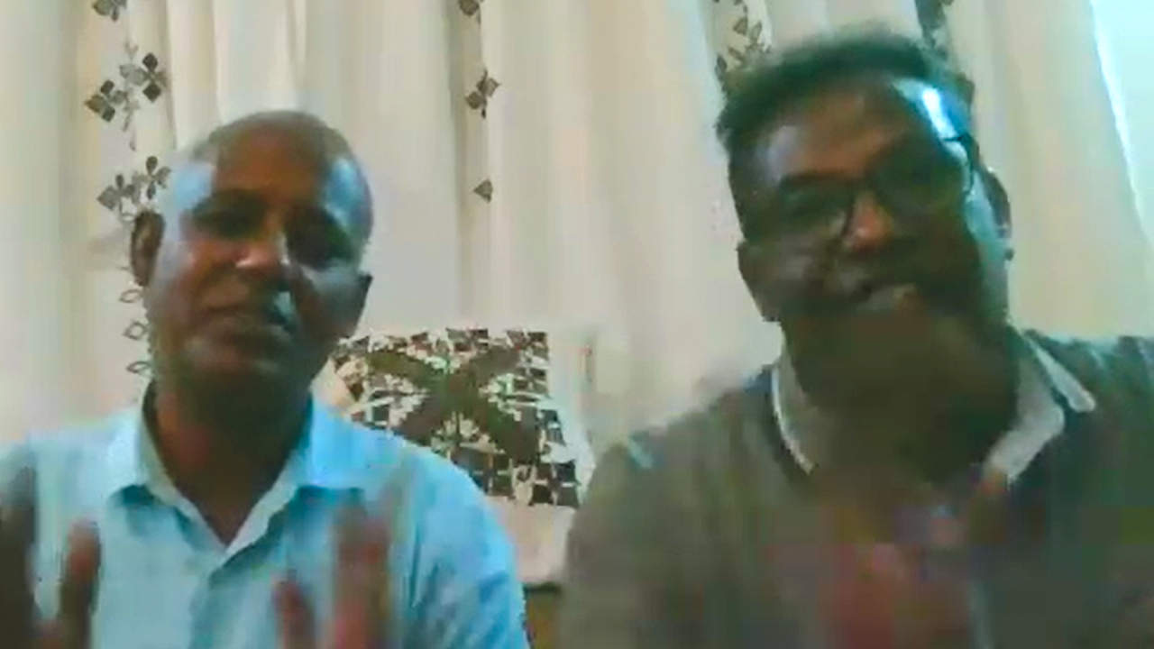 MKC Pastor Bekele Bejera, left, and Tefera Sori, MKC evangelist and missions director, speak with MC Canada representatives Feb. 10. — Mennonite Church Canada