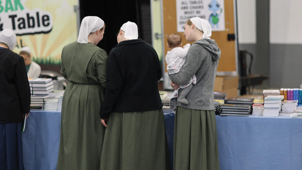 Anabaptist Identity Conference attendees browse Sermon on the Mount Publishing’s book table. — Patrick Matthews
