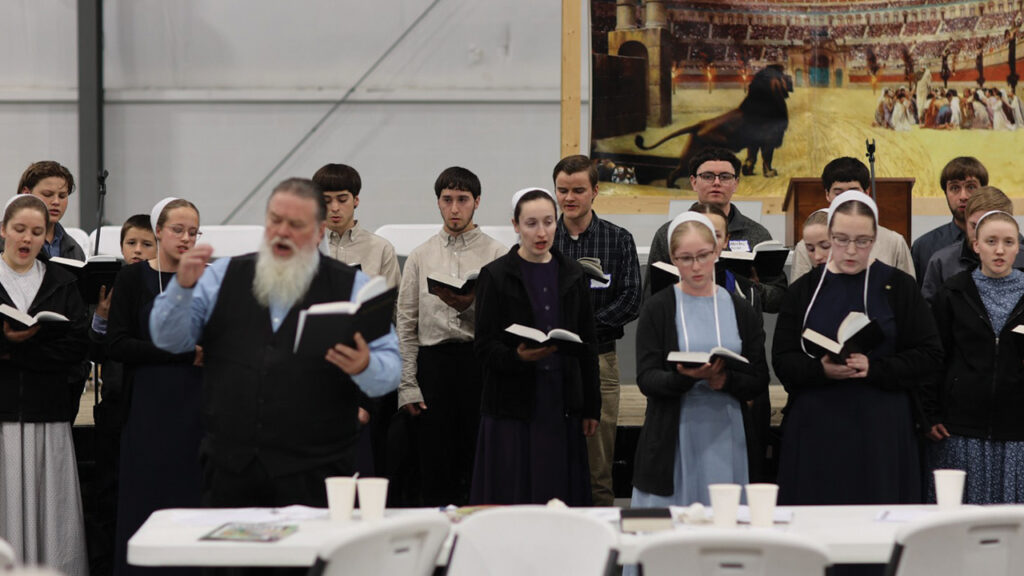 Youth sing from the Christian Hymnary in an impromptu chorus during the Anabaptist Identity Conference. — Patrick Matthews