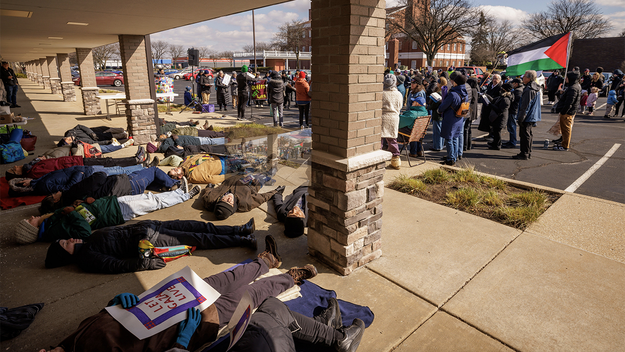 About two dozen participants lay outside Rep. Rudy Yakym’s Mishawaka, Ind., office March 27 in a “die-in” to symbolize the thousands of Palestinian civilians killed by weapons funded by U.S. tax funds. — Peter Ringenberg