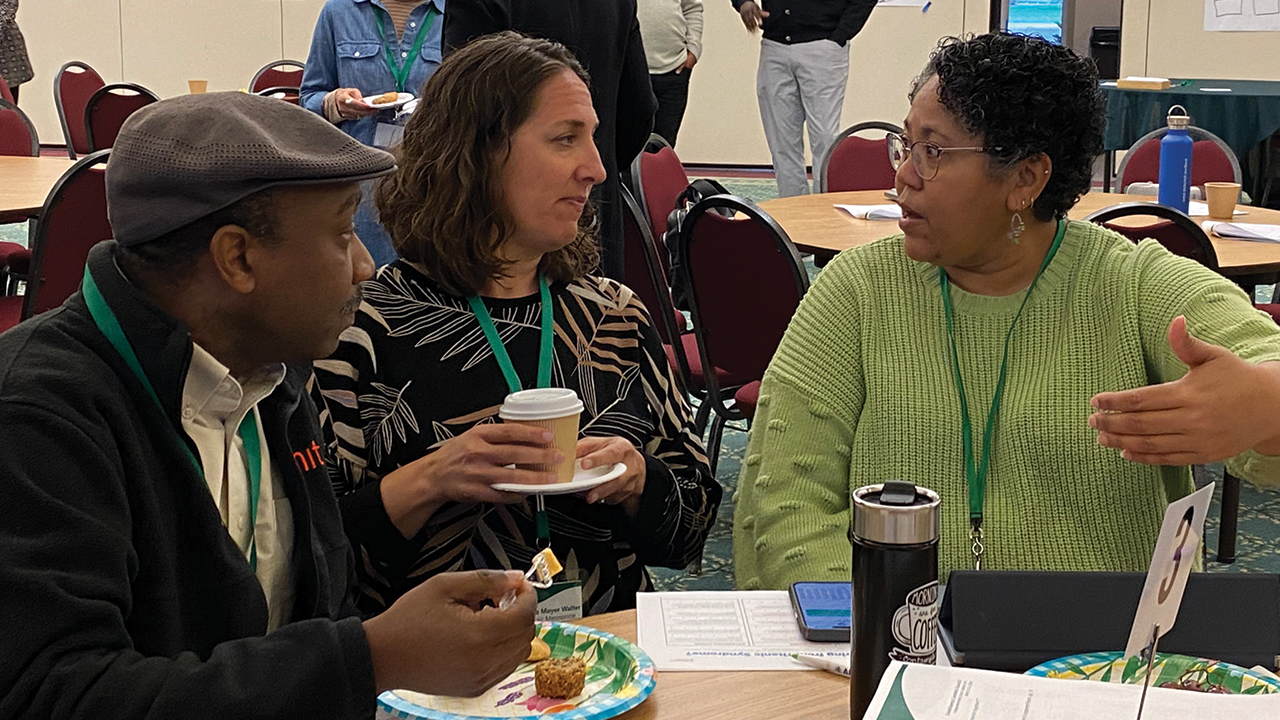 Emmanuel Mwaipopo, left, intercultural committee chair of Mosaic Mennonite Conference’s board, and Mosaic moderator Angela Moyer Walter listen to Mennonite Mission Network executive director Marisa Smucker, right. — Mennonite Church USA