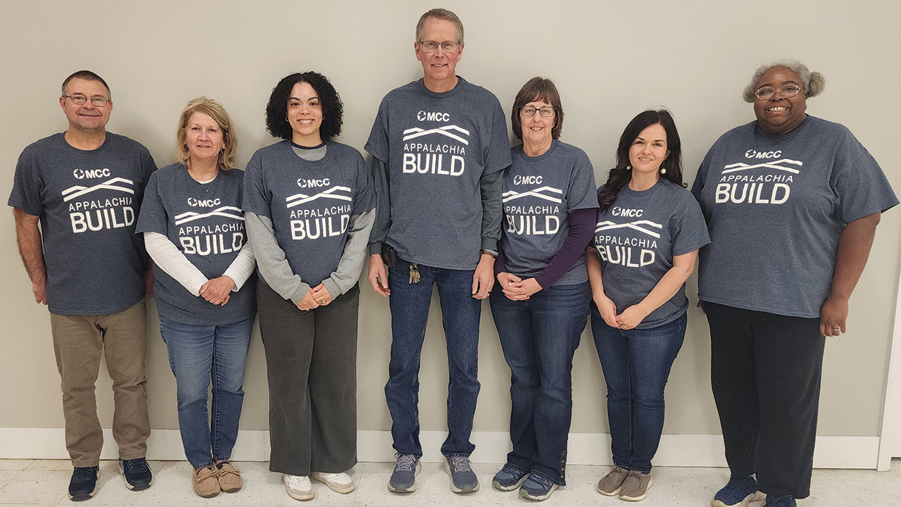 MCC Appalachia Build staff model T-shirts with the new program logo, replacing the former name, Sharing With Appalachian People. — Jennifer Steiner/MCC