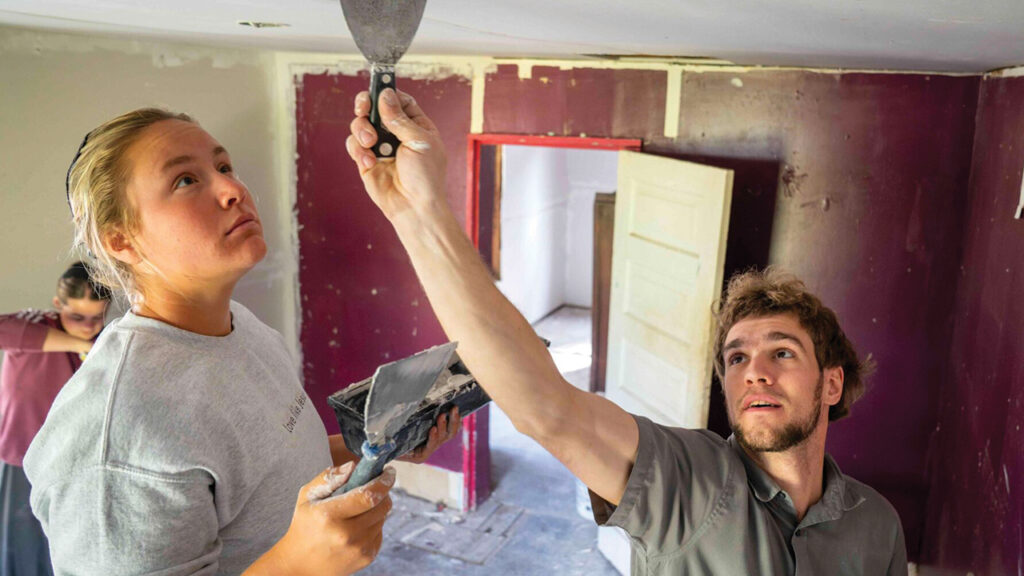 Volunteers Cindy Yoder and Bruce Raber work on Doris Hale’s home. — Mennonite Disaster Service