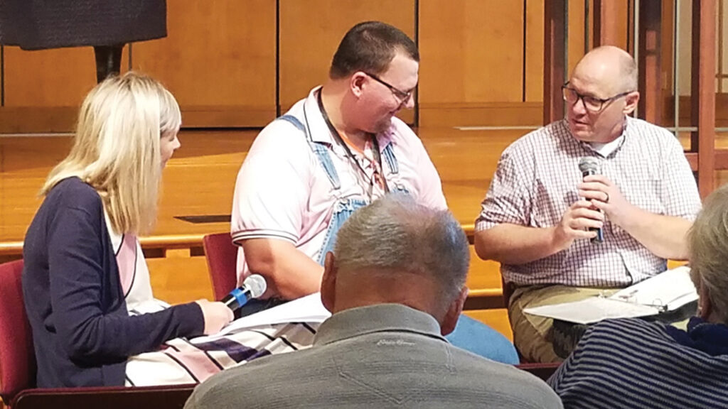 Amanda Swartley and Derek Yoder ask Robert Silvers questions before his baptism. — Megan Sandberg