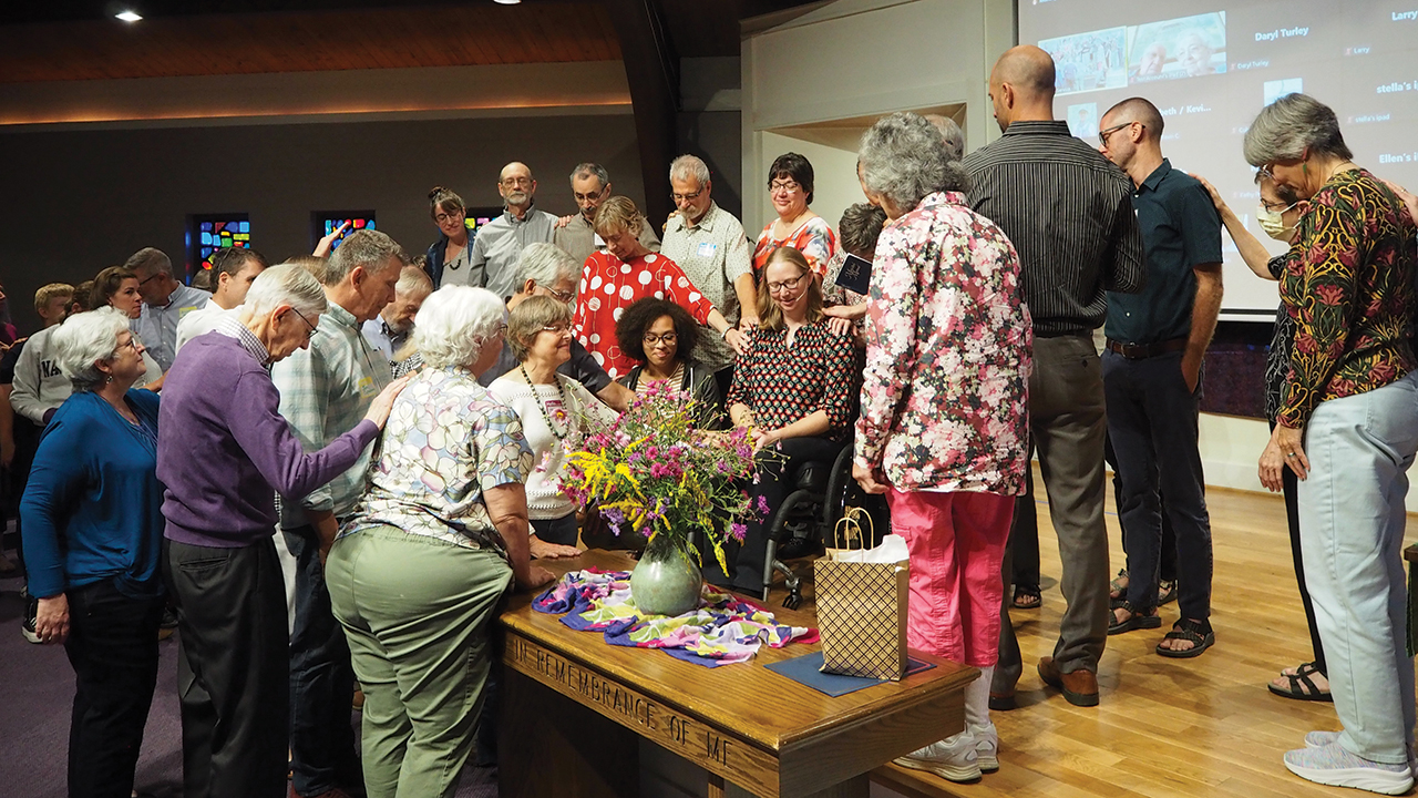 Members of Columbus Mennonite Church in Ohio pray for Sarah Werner during her ordination as a minister of the Word on Sept. 17. — John Rintoul