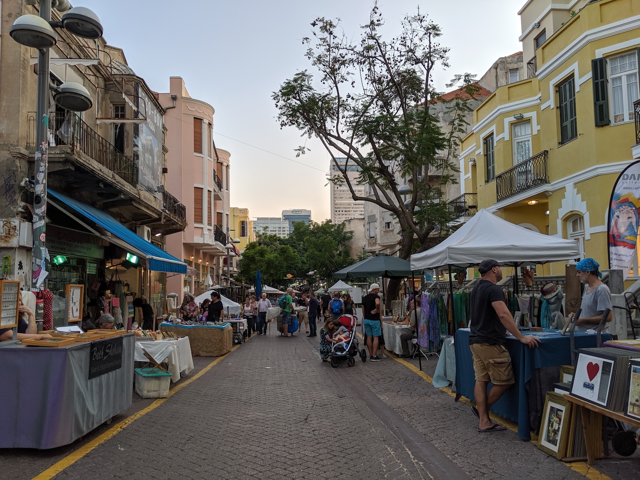 Street with vendor tents and stands on either side.