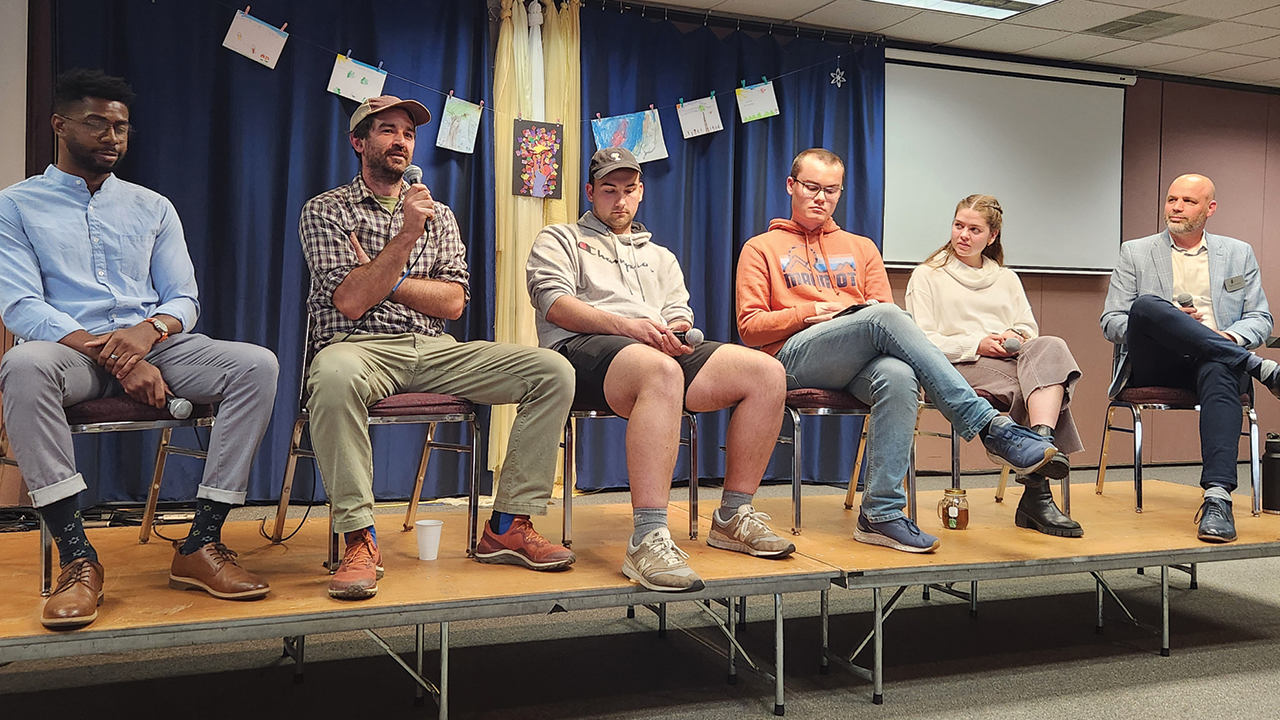 Panelists take part in a conversation on peace and conscientious objection at Eastern Mennonite School. From left are Ami, Tim Showalter, Adam Stoltzfus, Aidan Yoder, Sara Kennel and moderator Ben Bixler, a member of the EMS faculty. — Trisha Blosser/EMS