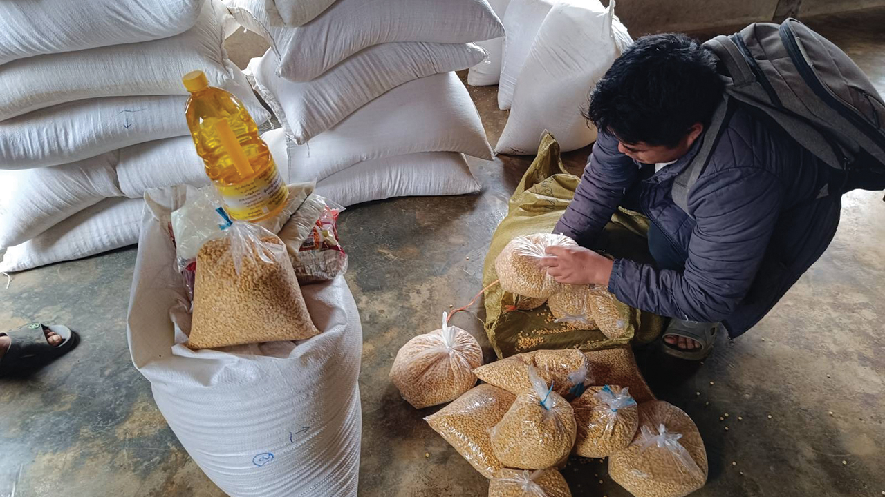 Food parcels are prepared for distribution to internally displaced people in Myanmar. This person is not named for their protection. They are not the person named Mr. Khong in the story. — Mennonite Central Committee