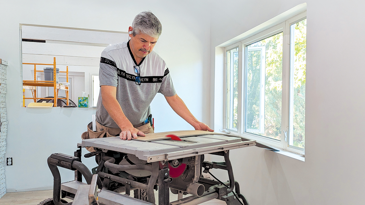 Jesus Martinez trims flooring in June on a jobsite. He was able to start his own carpentry company with the assistance of members of Faith Mennonite Church in Newton, Kan. — Tim Huber/AW