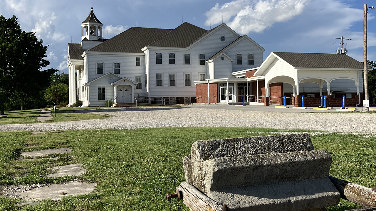 Symbolic of pioneer life, a threshing stone marks the path to Alexanderwohl Mennonite Church at Goessel, a central location of the Kansas Mennonite settlement in 1874. — Paul Schrag/AW