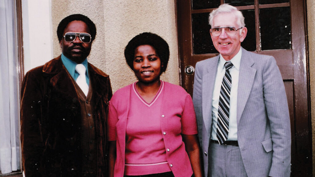 Elias Moyo, left, founder of the Brethren in Christ Church United Kingdom, stands outside his London flat in an undated photo with his wife Fadzai and Roy Sider, then-director of Brethren in Christ World Missions. — Brethren in Christ Historical Library and Archives