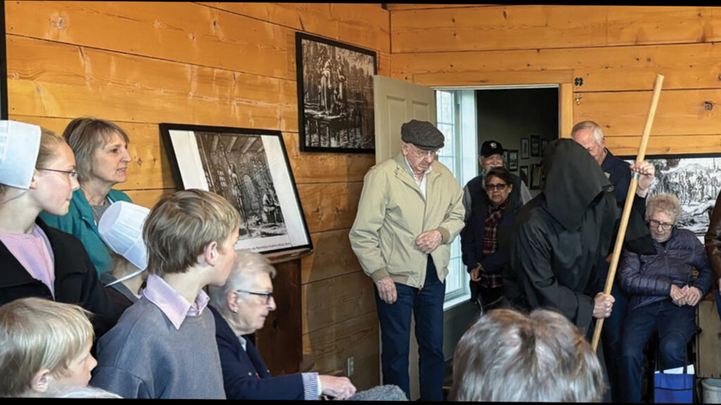 A cloaked jailer describes methods of punishment endured by 16th-century Anabaptists during a “Living the Anabaptist Story” event on April 21 at Henderson Mennonite Heritage Park in Nebraska. — Kerri Pankratz/York News-Times