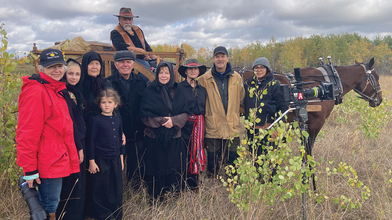 Dale Hildebrand, second from right, with documentary cast and crew from a scene with a Red River (Métis) ox cart. Métis are descendants of French and Scottish fur traders who married Indigenous women. They helped the Mennonite settlers, transporting them in Red River carts to their new homes. — Courtesy of Dale Hildebrand