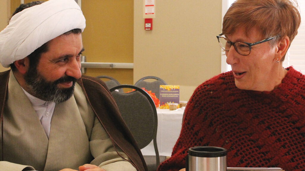 Scholars Muhammad Ali Shomali of Iran and Irma Fast Dueck of Canada talk during a Christian-Muslim dialogue in Edmonton, Alberta, in 2017. — Donita Wiebe-Neufeld