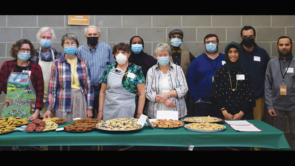 People from Holyrood and First Mennonite churches in Edmonton, with members of the local Muslim community, with “Mennonite cookies” they made for a community Iftar (breaking the fast during Ramadan) in 2022. — Courtesy of Suzanne Gross