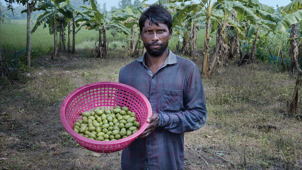 Kabir Hossain shows olives he brought to sell. “We would like to save our environment,” he says. — Fabeha Monir/MCC/Fairpicture