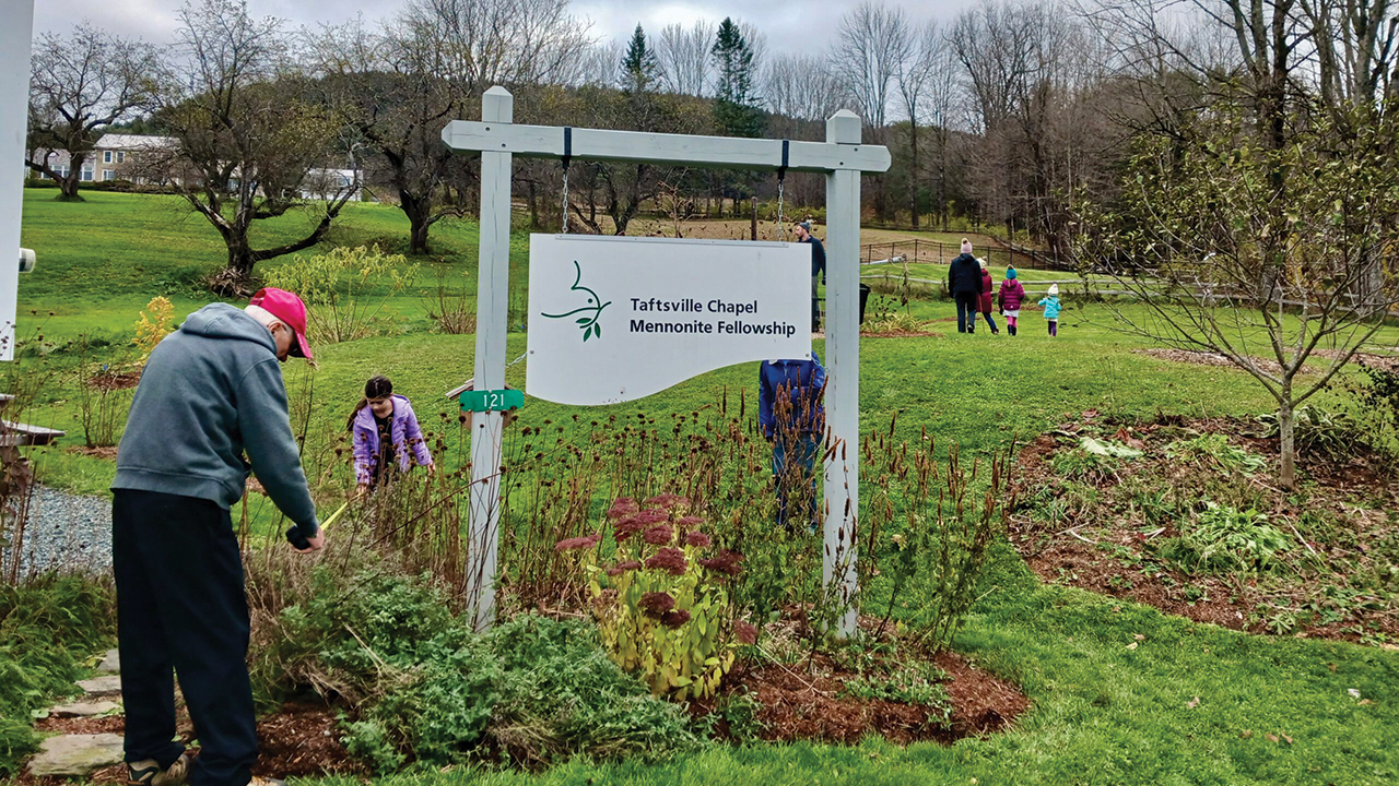 Richard Glick and Ella Good measure a pollinator patch garden at Taftsville Chapel Mennonite Fellowship in Vermont. —Mennonite Church USA