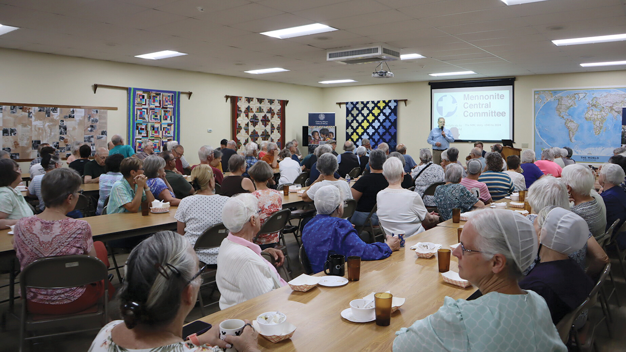 Volunteers at the MCC East Coast Material Resources Center gather in the dining hall after the groundbreaking. — Laura Pauls-Thomas/MCC