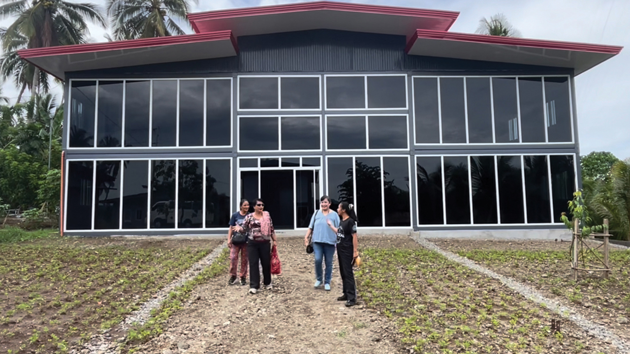 Tala Bautista, right, and Joji Pantoja, second from right, speak with Marilou Alngag and Leticia Joy Alngag of an Indigenous group in north Luzon at the Malipayon Peace Hub in the Philippines. — Mennonite Church Canada International Witness