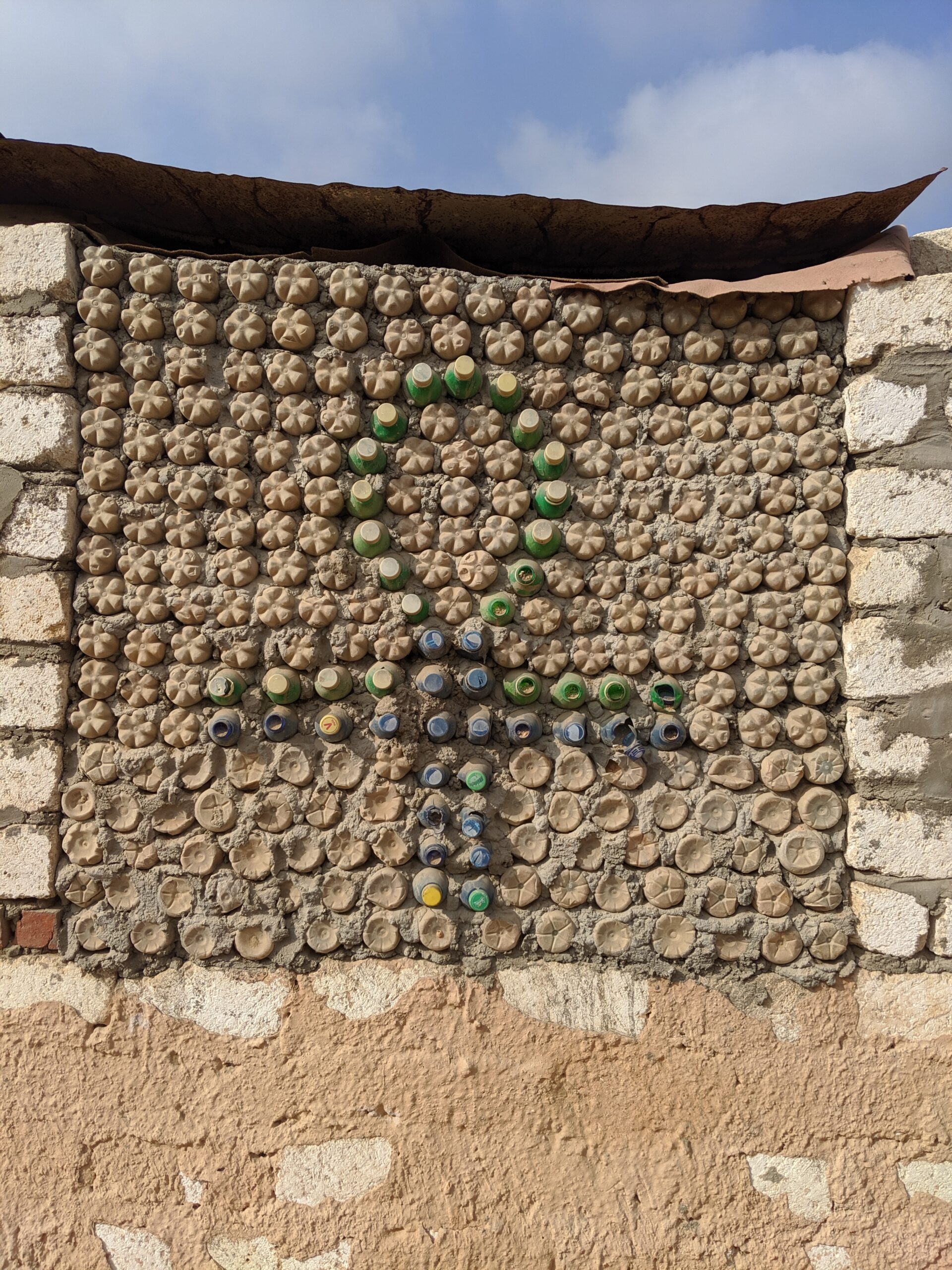 Wall made out of plastic bottles filled with sand. Anaphora, Egypt. From Andrea De Avila.