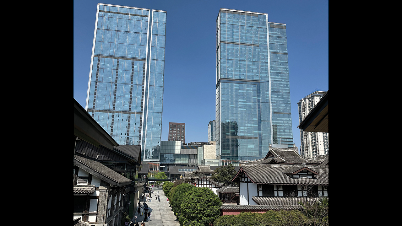 Modern office towers in Chengdu share space with traditional Chinese architecture, which in this image are high-end restaurants and stores for Western brands such as Gucci and Louis Vuitton. — Myrrl Byler/Mennonite Church Canada
