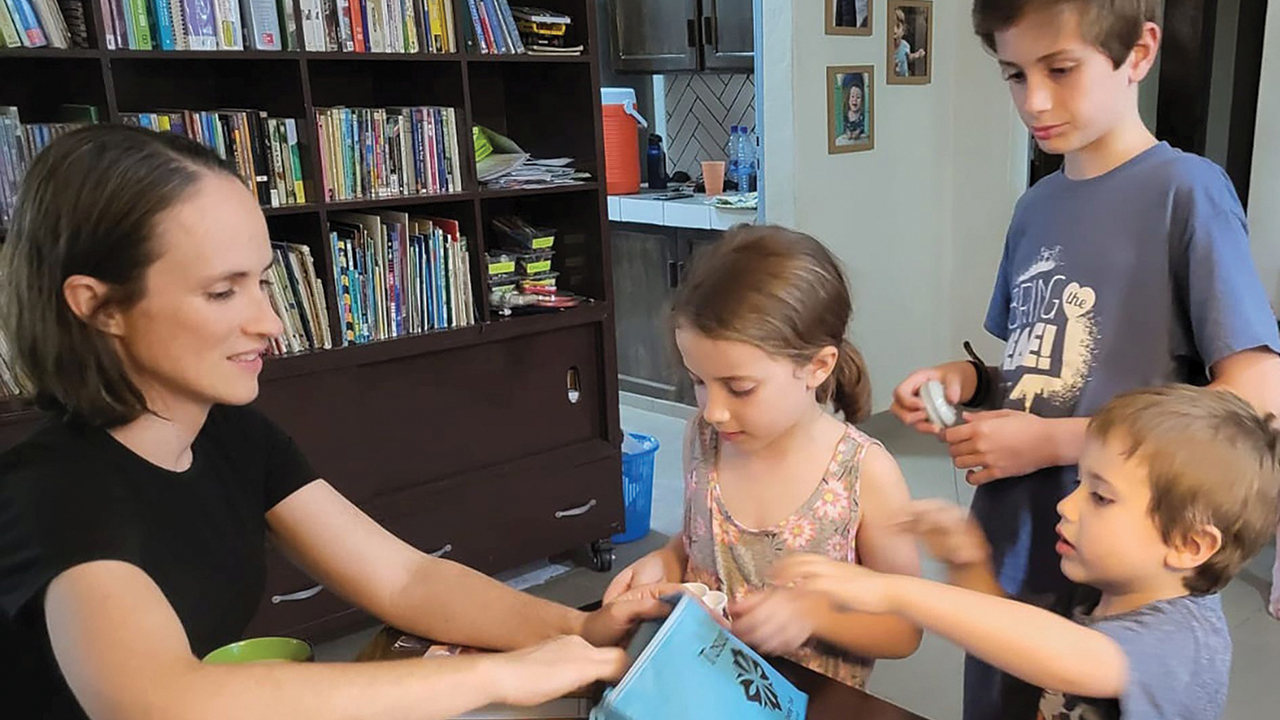 Christy Harrison and her children, Celeste, Moses and Felix, work on an art project at home in Chad. — Peter Sensenig/MMN