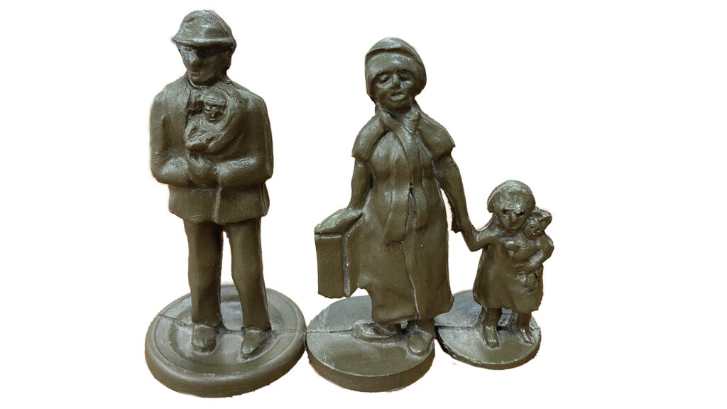 “Refugee Family Sculpture” by Randy Regier, 2016. Cast resin edition of multiples. This one was displayed at the Newton Public Library in Kansas. — Rachel Epp Buller