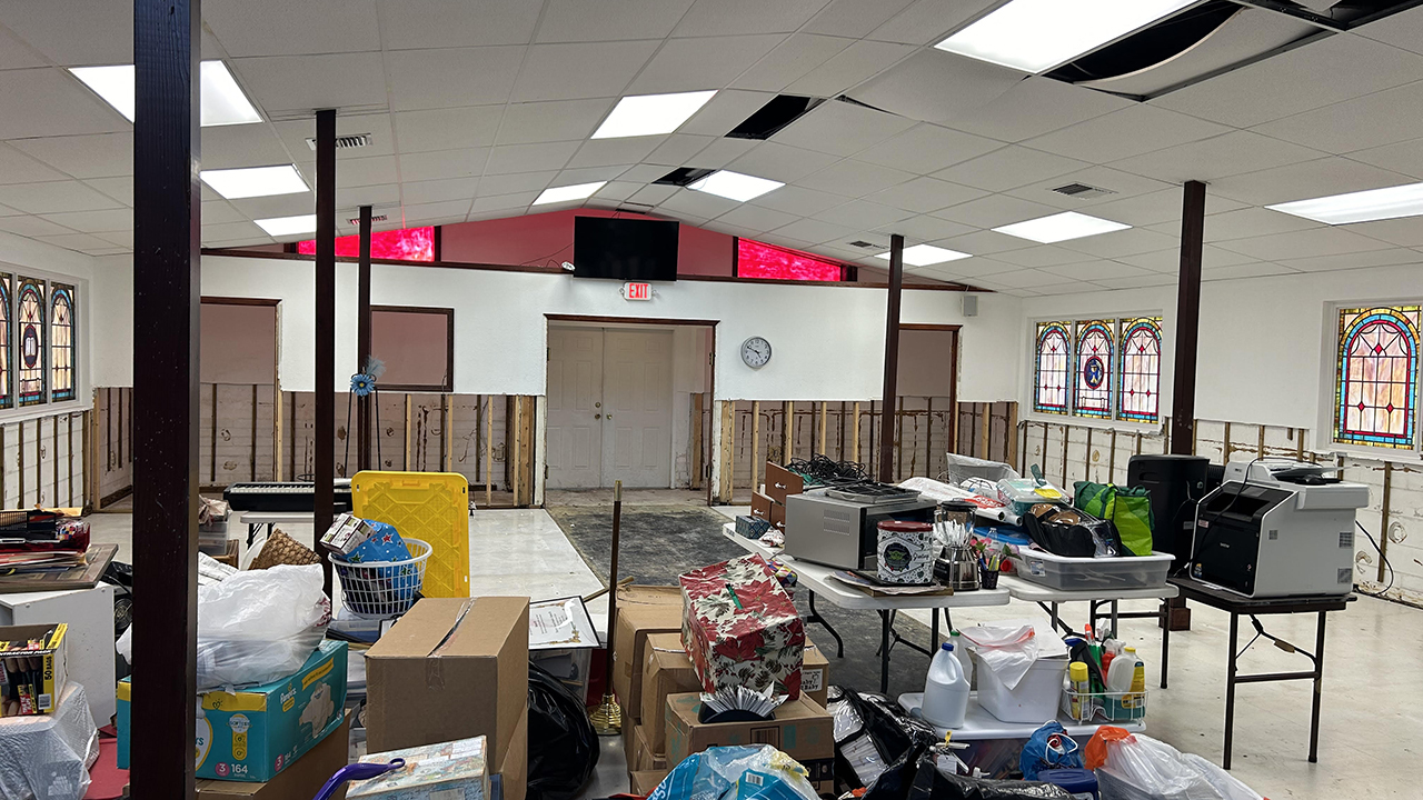 Mennonite Disaster Service volunteers are cleaning mud off floors and tearing out some drywall at an African Methodist Episcopal church in Punta Gorda, Fla. The sanctuary was renovated after Hurricane Ian flooded the area in 2022, and the building hosted its first meeting a week before Hurricane Milton struck in October. — Larry Stoner/MDS