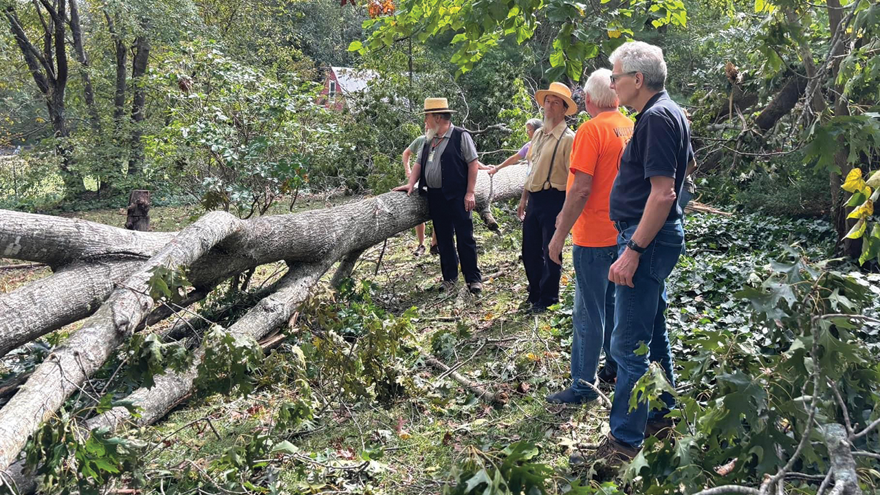 Mennonite Disaster Service executive director Kevin King, right, evaluates hurricane damage Oct. 1 in the Asheville, N.C., area. — Mennonite Disaster Service