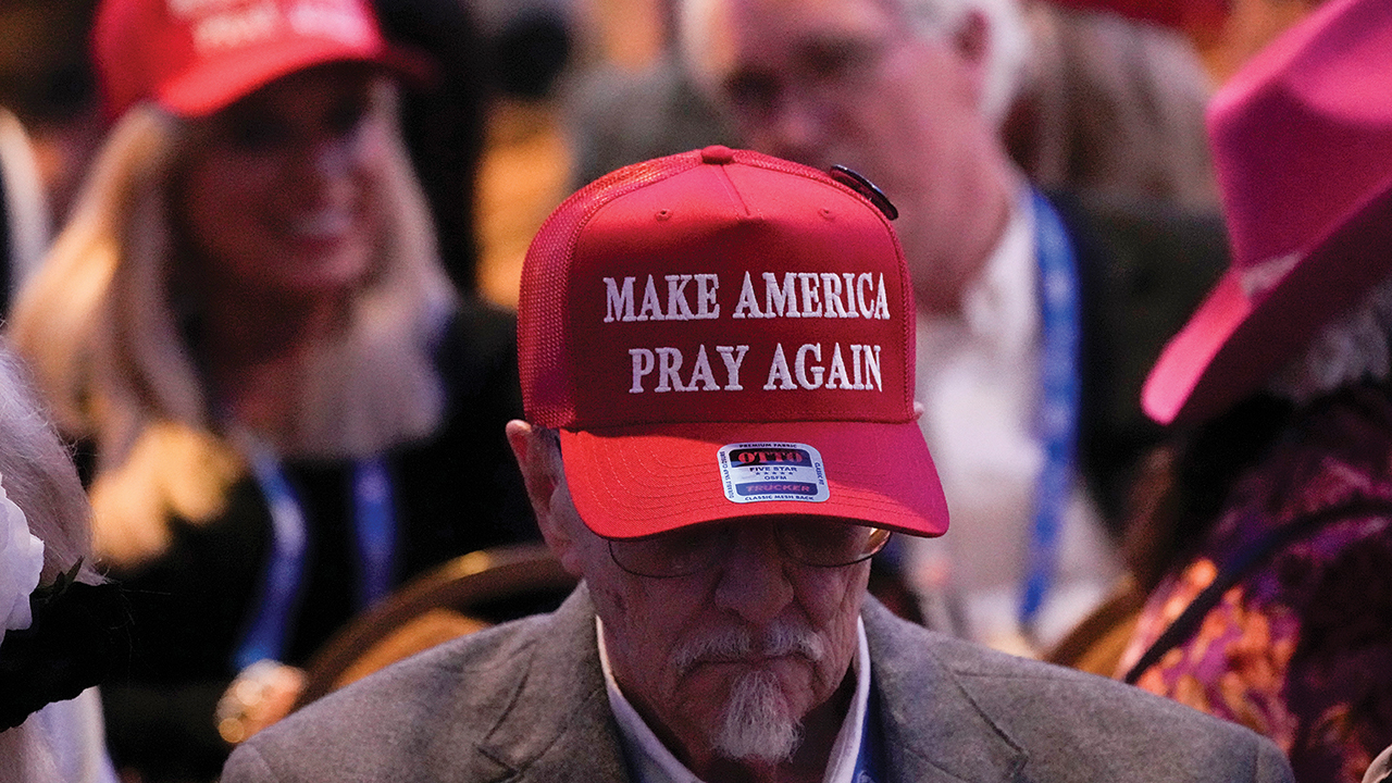A man wears a Make America Pray Again hat before Donald Trump speaks at the National Religious Broadcasters convention Feb. 22 in Nashville, Tenn. — George Walker IV/Associated Press