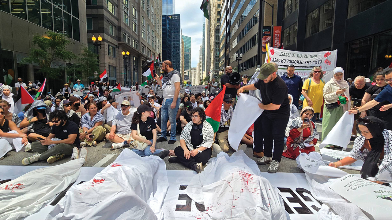 Protesters gather in front of the American Israel Public Affairs Committee office in Chicago, calling for an end to U.S. military aid to Israel, on June 22. Those lying under sheets symbolize the dead in Gaza. — Michael Bracey