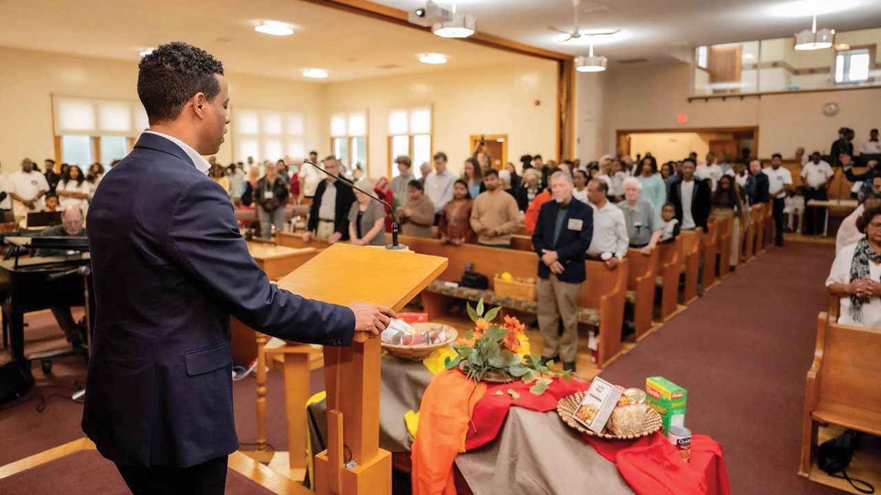 Jonathan Abrham, pastor of Shalom Worship and Healing Center, speaks as the congregations celebrate shared ownership of the building Oct. 13. — Mennonite Church Eastern Canada