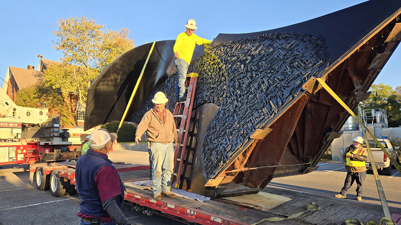 Workers load the sculpture for transport on the campus of Eastern Mennonite University in Harrisonburg, Va. — John Augsburger