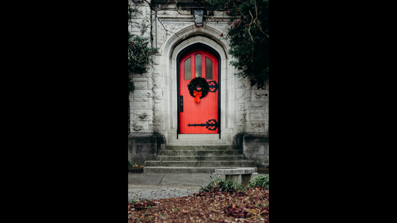 red church door with Christmas wreath