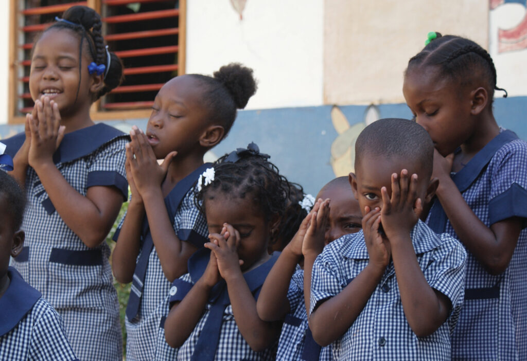 ONGOING RENEWAL — Children from Faith Mennonite Church in Spanish Town, Jamaica, participate in morning prayers to begin their day at the church’s preschool on March 7, 2011. —Galen Lehman/MWC