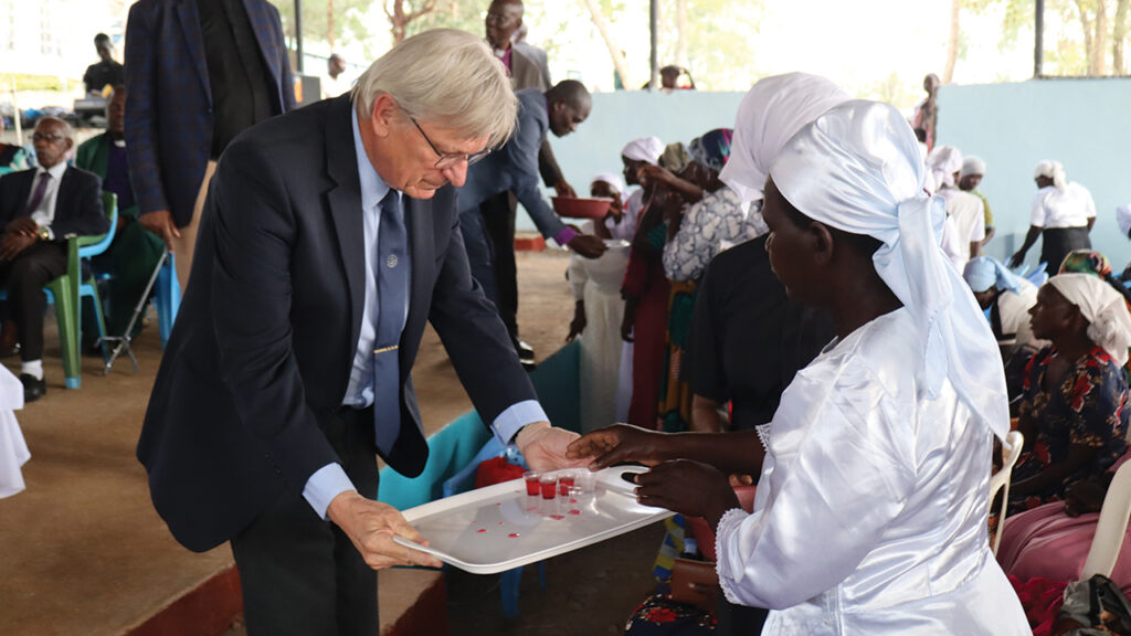 IN REMEMBRANCE — Deaconess Benter Chacha, right, a leader in the Kenya Mennonite Church Southern Diocese, takes part in the Lord’s Supper with Mennonite World Conference President Henk Stenvers in August 2023 during KMC’s national convention in Migori, Kenya. — Mennonite World Conference
