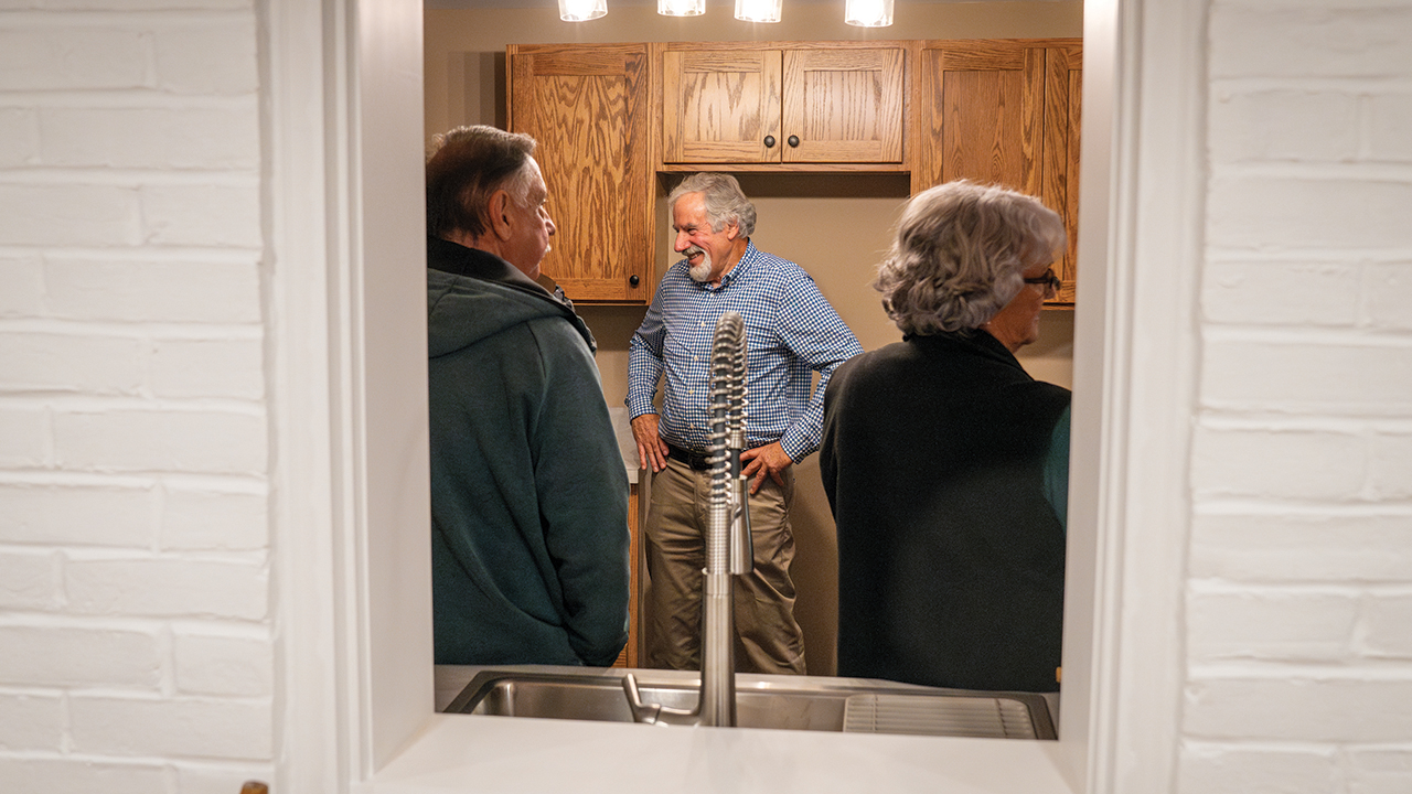 Guests mingle Nov. 17 in the Compassion House’s new kitchen the day of the home’s dedication. — Paul Hunt/MDS