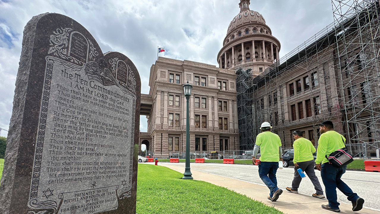 NO OTHER GODS — Construction workers walk past a monument of the Ten Commandments outside the state Capitol in Austin, Texas, on June 20, 2024. — Paul Weber/AP