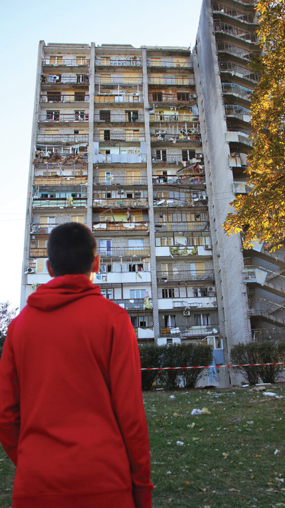 A boy observes an apartment complex in Zaporizhzhye, Ukraine, the day after it was hit by a Russian airstrike on Oct. 1. — AMBCU
